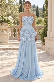 Elegantly designed for your special night, this stunning blue A-line prom dress features a strapless neckline and delicate 3D floral details. The flowing chiffon fabric drapes beautifully with precise pleating throughout, creating a graceful silhouette that flatters every figure.