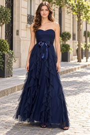 Stunning navy blue prom dress featuring an elegant strapless sweetheart neckline adorned with delicate tulle ruffles and a graceful bow accent. Perfect for creating an unforgettable entrance at any formal event.&nbsp;