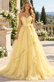 Radiant and romantic, this stunning A-line prom dress captivates in vibrant yellow tulle. The sweetheart neckline frames your shoulders beautifully while delicate appliqués add intricate detail and dimension.