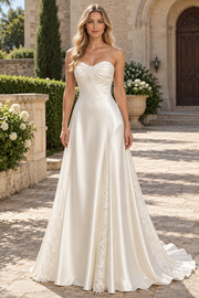 Elegant white A-line prom dress featuring a strapless sweetheart neckline and delicate lace appliqués on luxurious satin fabric. This timeless evening gown combines classic silhouette with romantic detailing, perfect for formal events, proms, and special occasions.&nbsp;