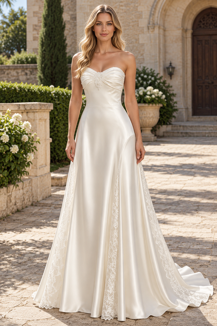 Elegant white A-line prom dress featuring a strapless sweetheart neckline and delicate lace appliqués on luxurious satin fabric. This timeless evening gown combines classic silhouette with romantic detailing, perfect for formal events, proms, and special occasions.&nbsp;